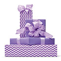 Gifts wrapped in purple and patterned wrapping paper.