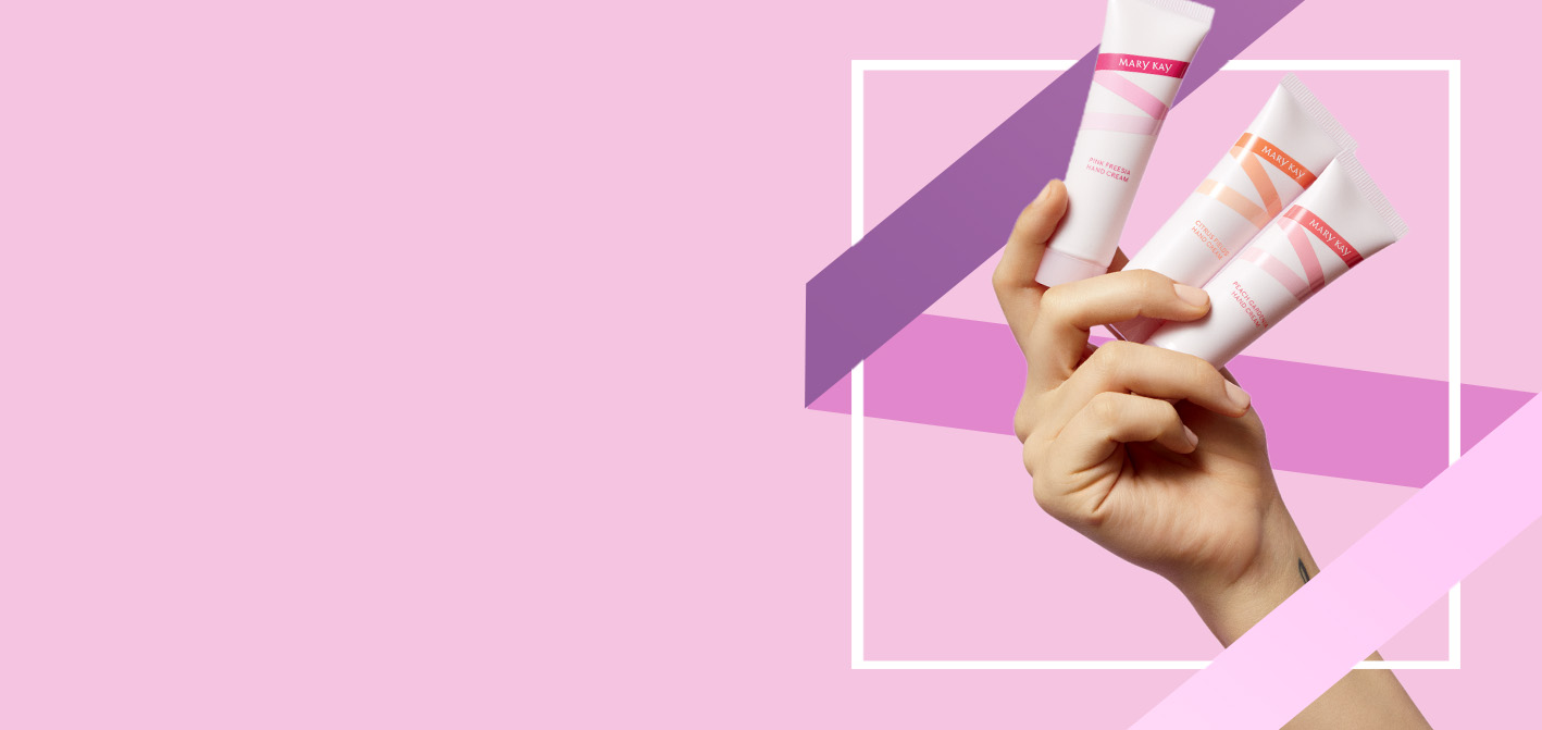 Hand holding limited-edition Mary Kay Hand Cream Minis