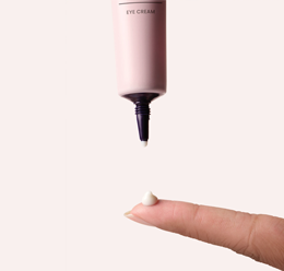 A picture of a small pink tube and a smear of TimeWise® Age Minimize 3D® Eye Cream