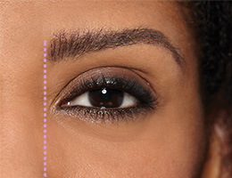 Extreme close-up of model with bold brows and dotted line showing where to begin