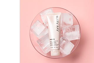 A tube of TimeWise Moisture Renewing Gel Mask is shown being chilled in a bowl of ice cubes.