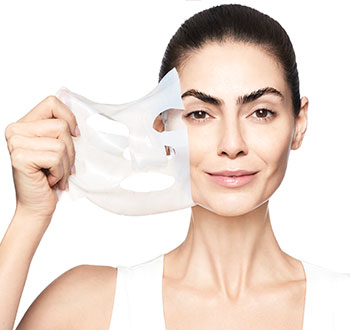 Learn more about the NEW TimeWise Repair Lifting Bio-Cellulose Mask from Mary Kay and how you can see a visible lift in just two weeks.  Image of smiling woman peeling mask from her radiant skin.