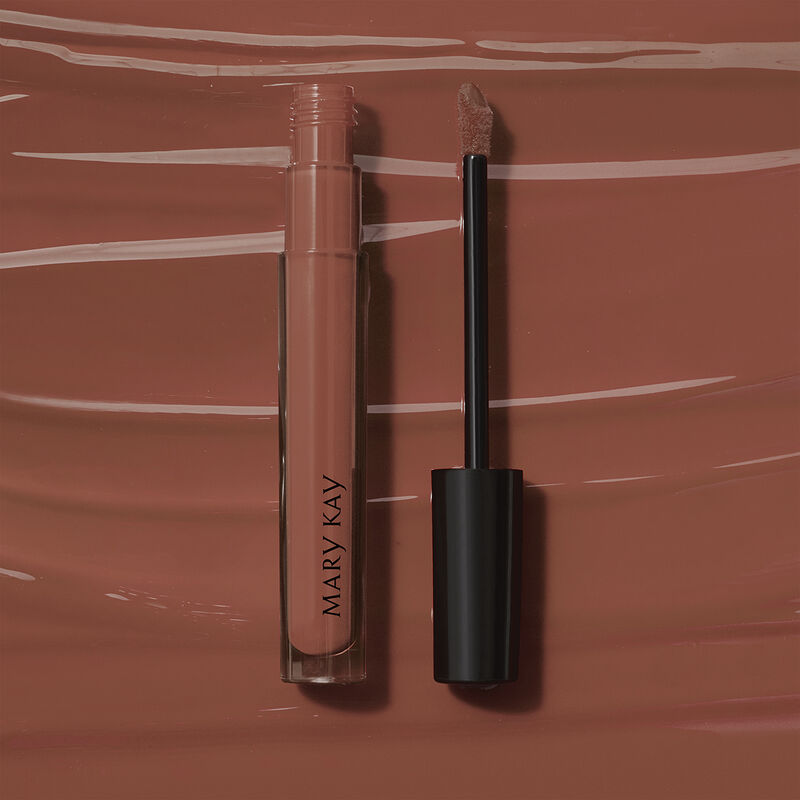 Open tube of Mary Kay Unlimited Lip Gloss in shade Tawny Nude against accompanying shade rub
