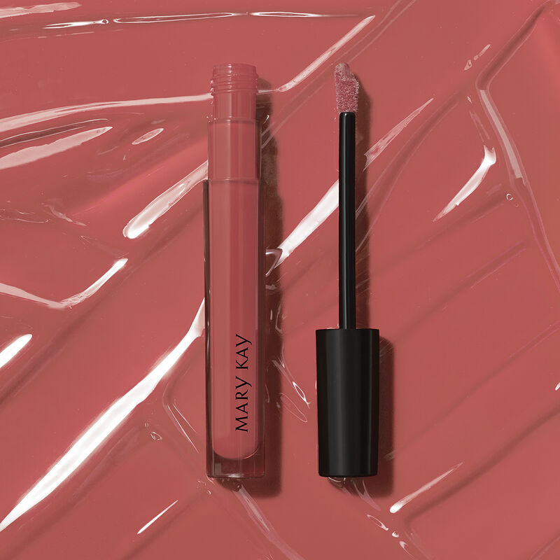 Open tube of Mary Kay Unlimited Lip Gloss in shade Unique Mauve against accompanying shade rub