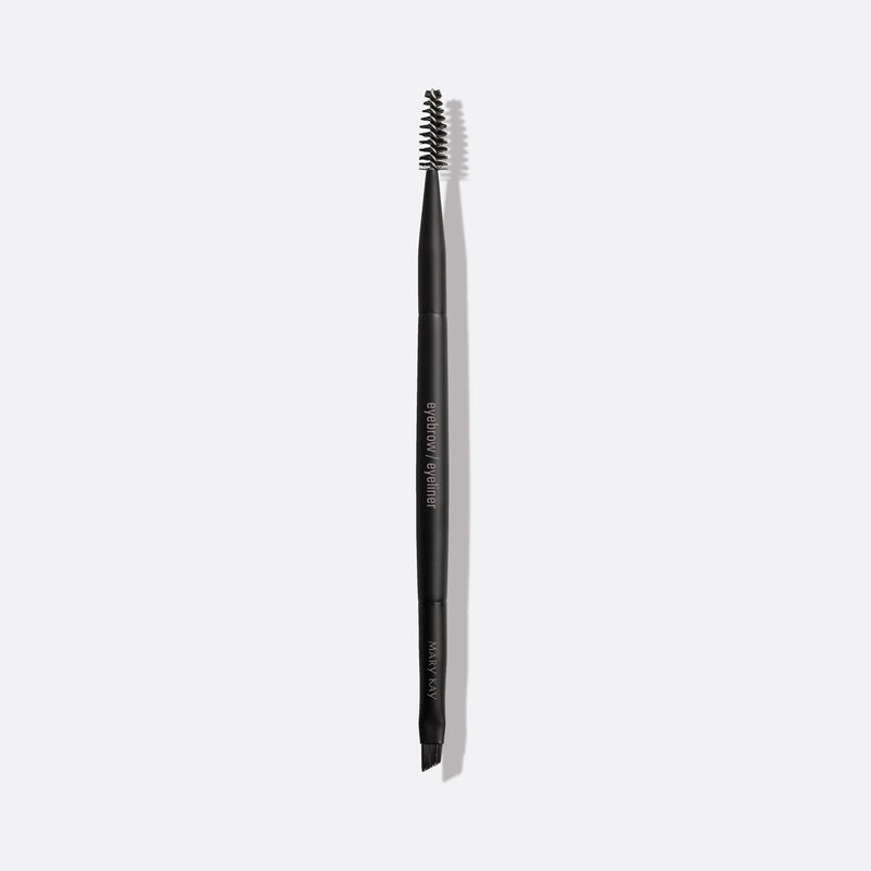 Mary Kay duel Eyebrow and Eyeliner Brush on a plain background.