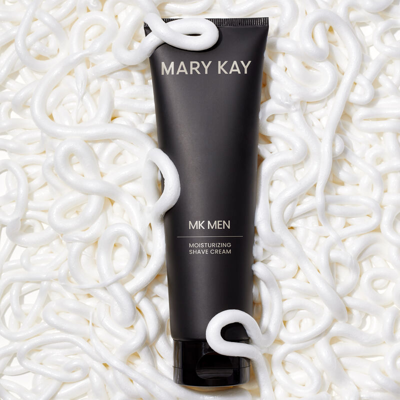 Bottle of MKMen Moisturizing Shave Cream surrounded by a bed of creamy product curls