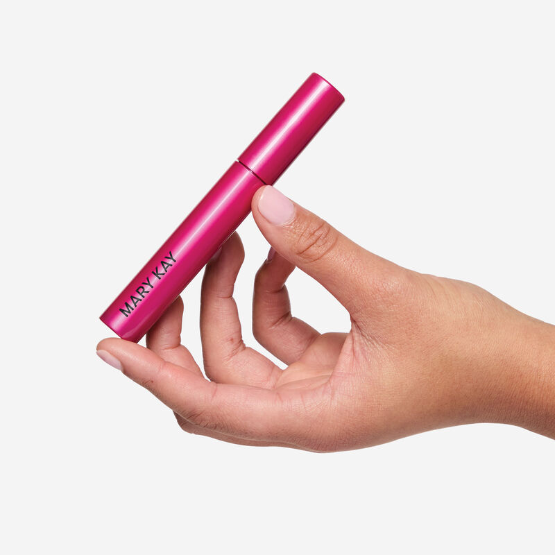 Hand holding Lash Love Fanorama Define Lift Mascara set against a white background