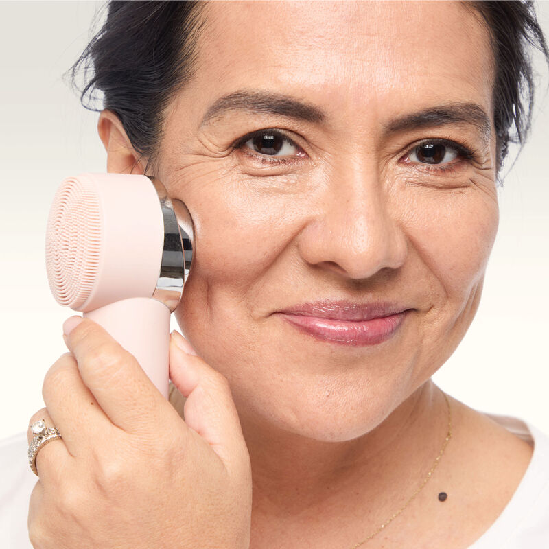 Model using the Thermal Massage side of the Mary Kay Skinvigorate Duo Facial Device