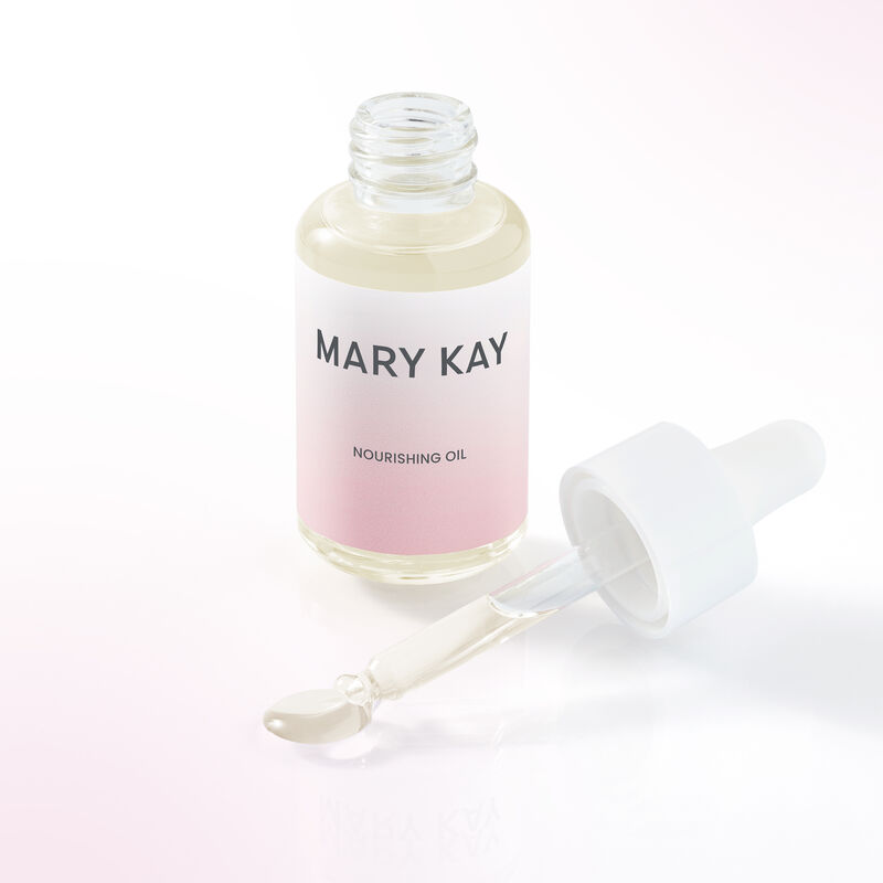 Bouteille ouverte de l&rsquo;Huile nourrissante Mary Kay &agrave; c&ocirc;t&eacute; du compte-gouttes duquel s&rsquo;&eacute;coule un peu d&rsquo;huile