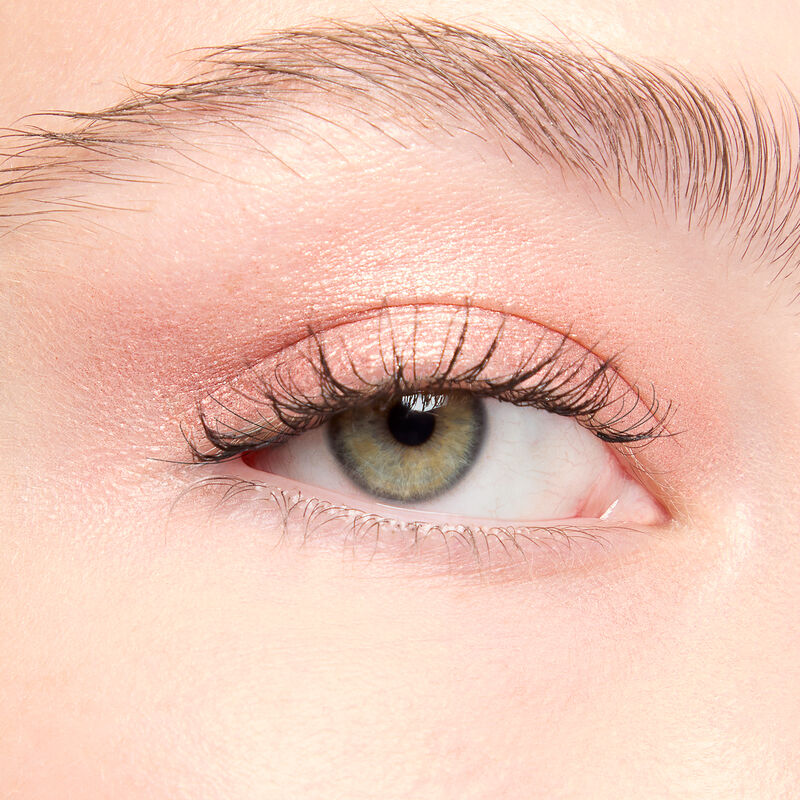 A model with a light skin tone and green eyes wears shade Copper Nova.&nbsp;