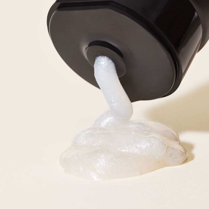 Closeup of limitededition MKMen Invigorating Face Scrub product being squeezed from the tube