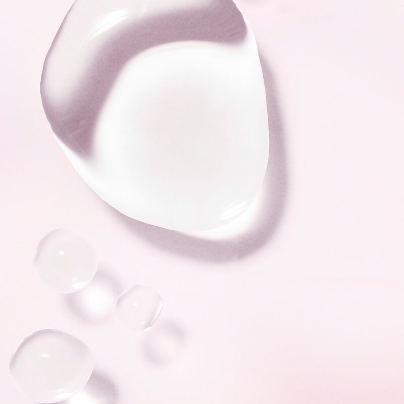 Product drops of Mary Kay Balancing Toner against light pink background