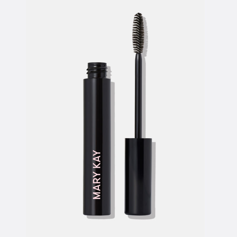 Tube of Mary Kay&reg; Ultimate Mascara standing beside applicator wand.