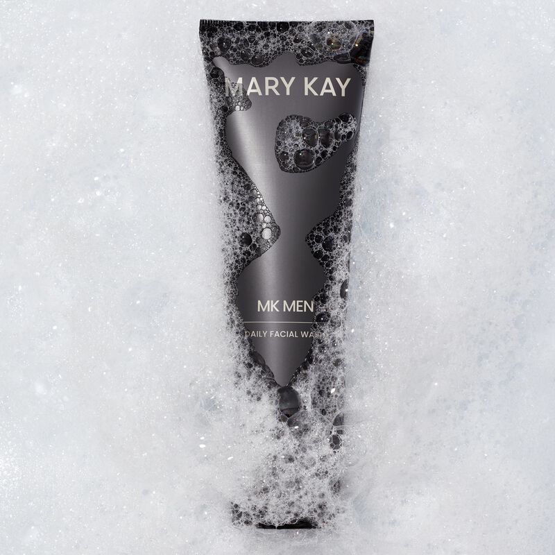 Bottle of MKMen Daily Facial Wash immersed in foamy bubbles