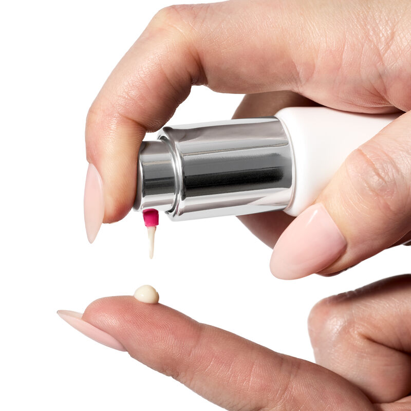 Hand squeezing product out of tube