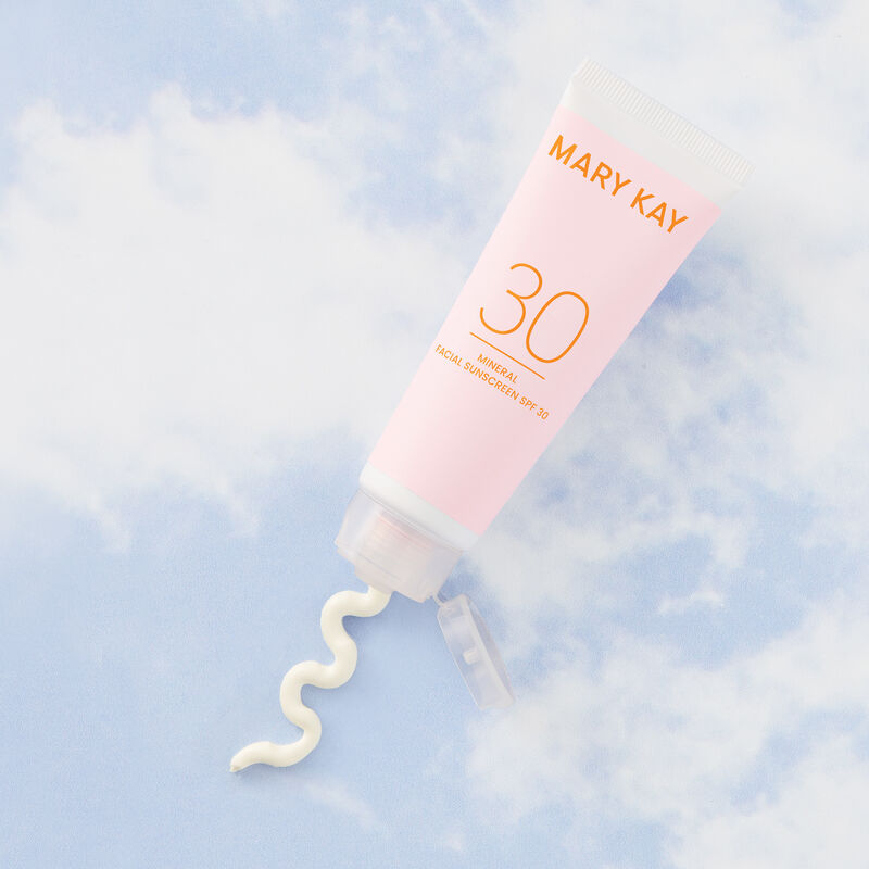 Mary Kay Mineral Facial Sunscreen with squirt of product on a sky background