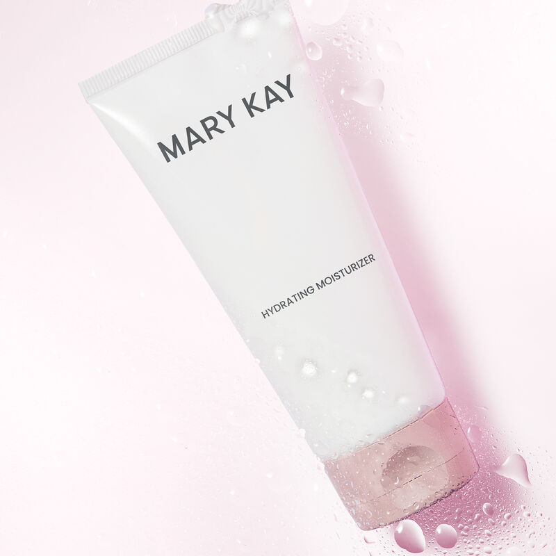 Mary Kay Hydrating Moisturizer beneath water droplets against light pink background