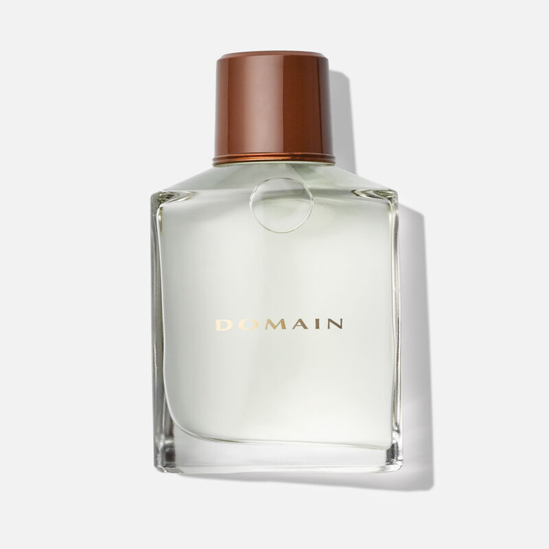 Bottle of Domain&reg; Cologne Spray on plain background.