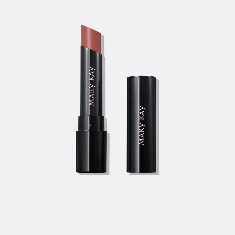 Uncapped tube of Mary Kay Supreme Hydrating Lipstick in shade Hushed Blush next to accompanying cap against plain background.