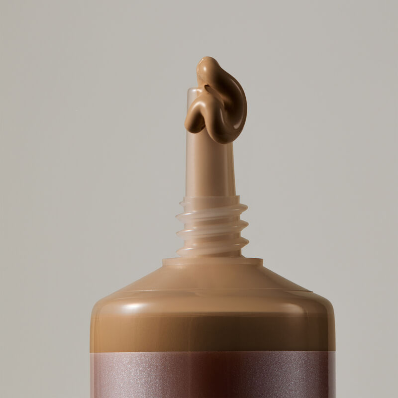 Macro view of TimeWise Matte 3D Foundation needle-nose applicator dispensing Deep 1 shade