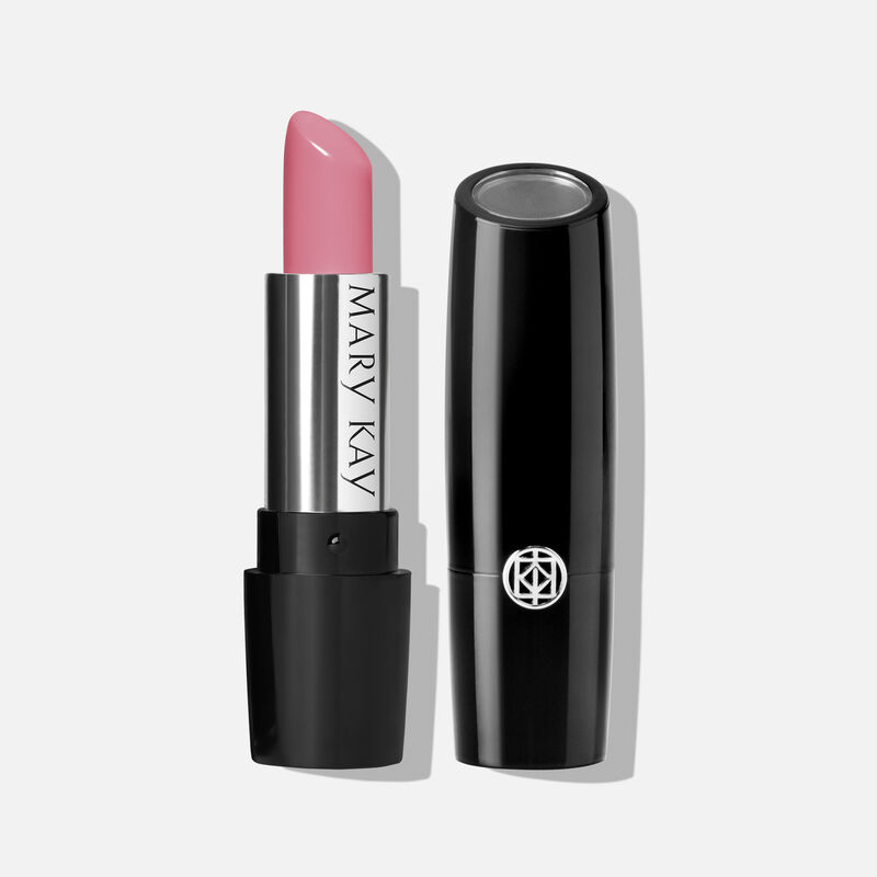 An open tube of Mary Kay Gel Semi-Shine Lipstick in the shade Love Me Pink next to accompanying cap.