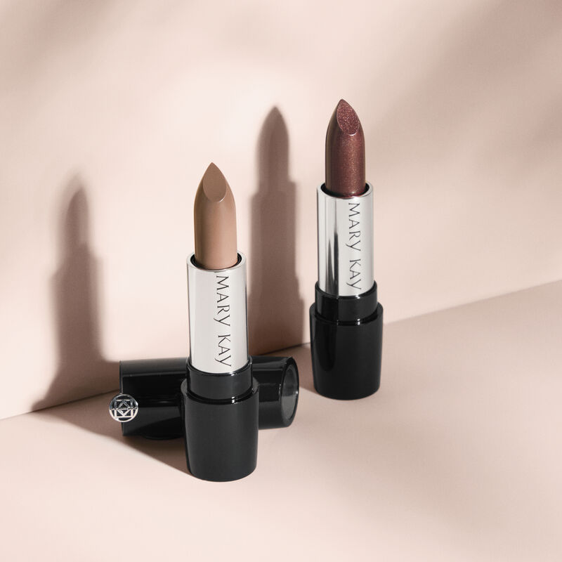 Uncapped tubes of Mary Kay Gel Semi-Matte Lipstick in Subdued Nude and Mary Kay Gel Semi-Shine Lipstick in Downtown Brown.