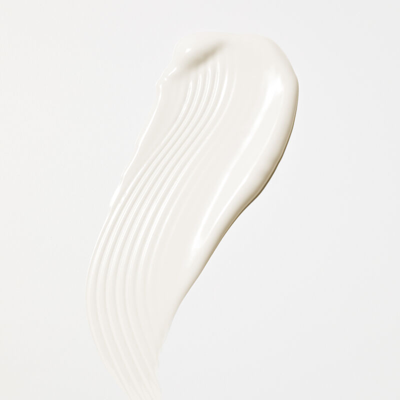 White swipe product rub of Mary Kay&reg; Sunscreen SPF 50+ on plain background