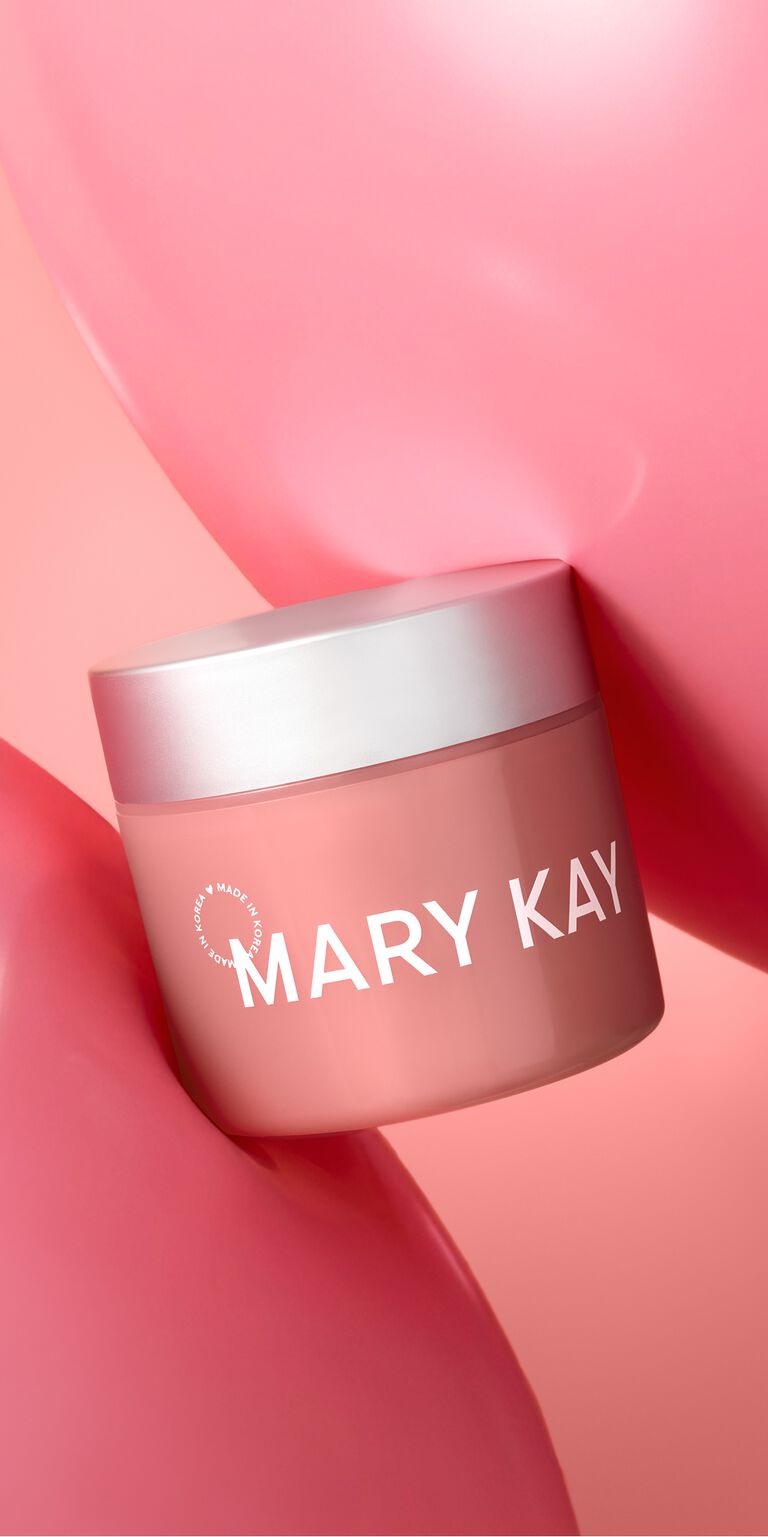 Jar of Mary Kay Collagen Moisturizing Gel resting between two pink gel smears