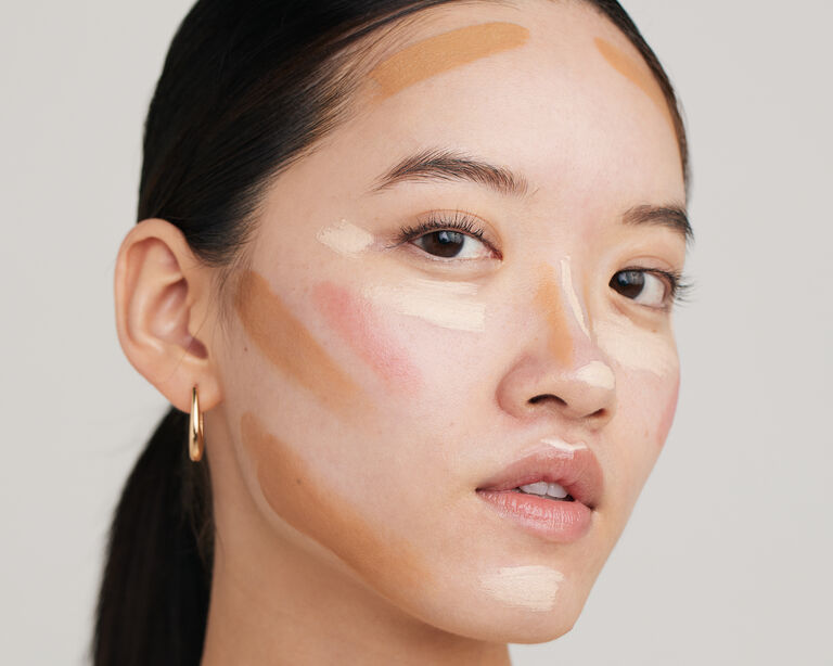Side-view of model with makeup swipes on her face