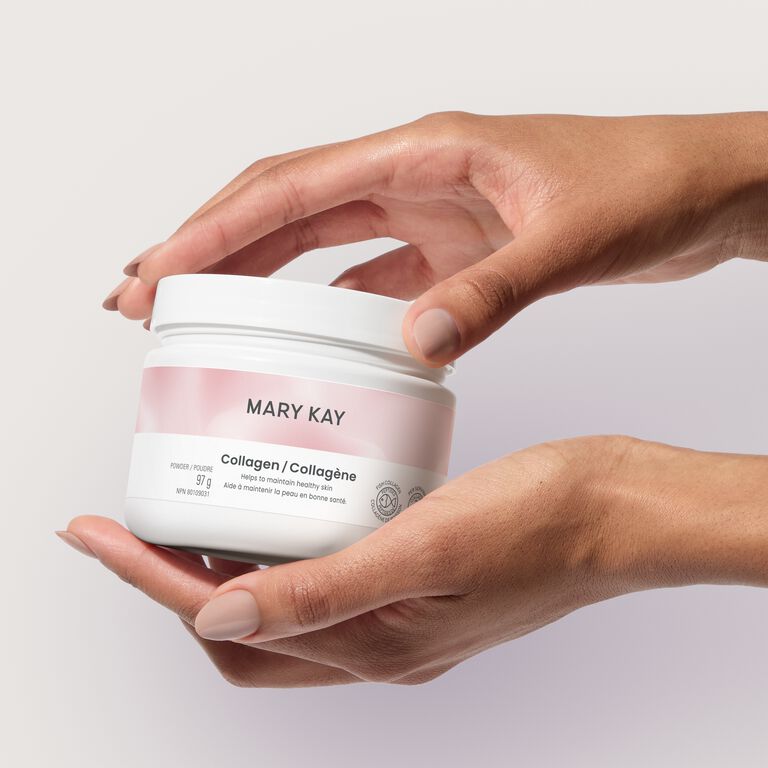 Hands holding Mary Kay collagen against a plain background