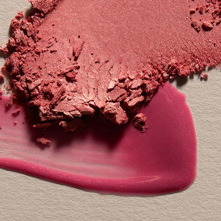 Product swatch featuring pink blush and lip gloss against a light background