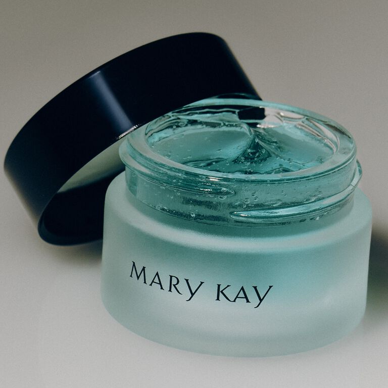 Open container with a black Mary Kay logo holding blue eye gel 