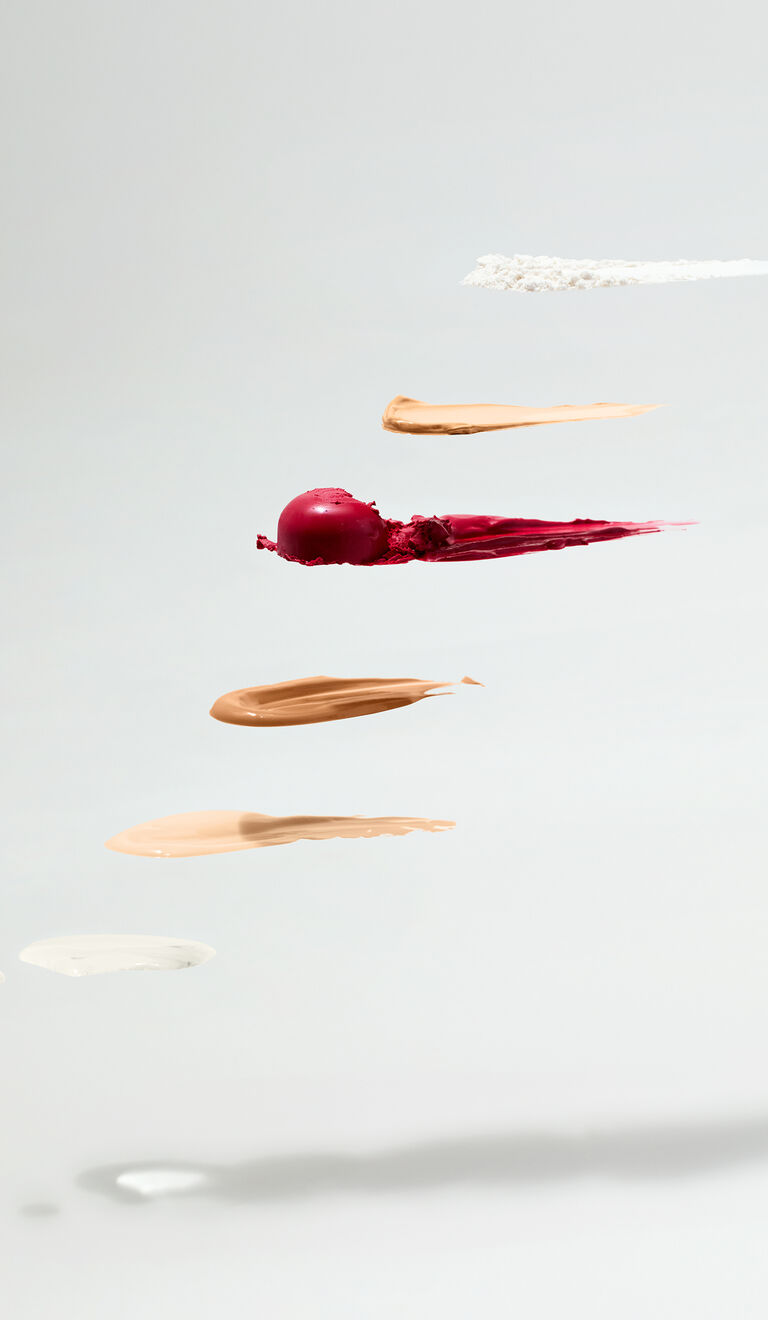 Rows of makeup product swipes in various shades against a light background