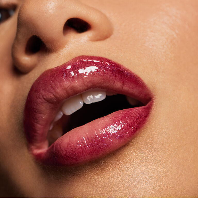 Close-up of glossy, berry-coloured lips