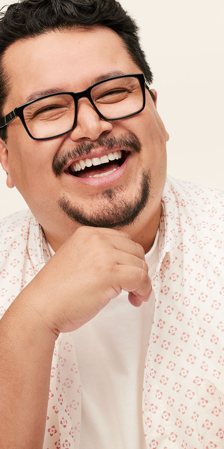 Male model laughing with his hand on his chin