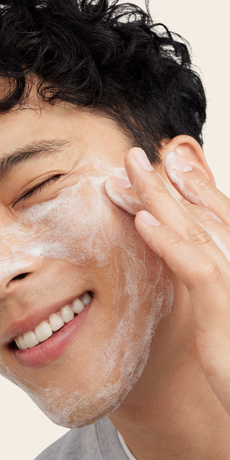 Male model applying Mary Kay  MKMen Daily Facial Wash to the side of his face
