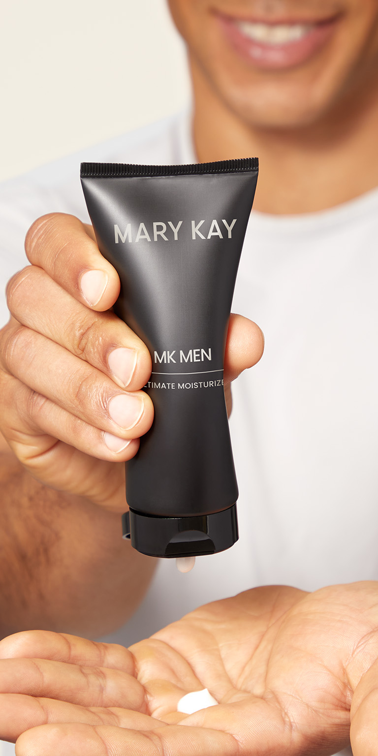 Male model squeezing Mary Kay MKMen moisturizer into his hand