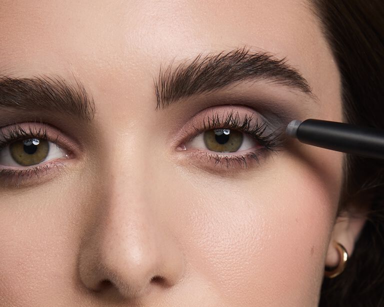 Close-up of model applying a second eyeshadow shade to her eyelid