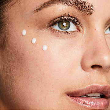 Woman with 3 dots of Mary Kay TimeWise Replenishing Serum C+E on her cheek