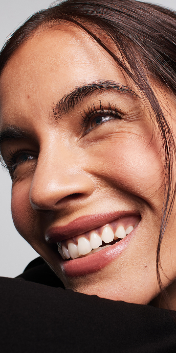 Women smiling with mascara applied