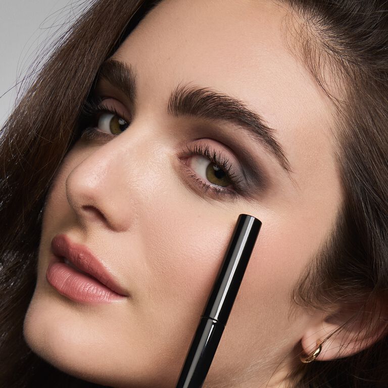 A brunette model showing off her matte eye shadow look.