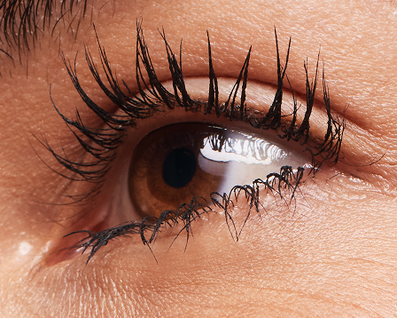 Three coats of Lash Love Fanorama Define+Lift Mascara applied to lashes of a model with light skin tone