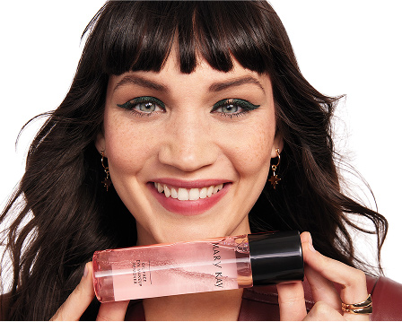 Female model holding Mary Kay Oil Free Eye Makeup Remover to her face