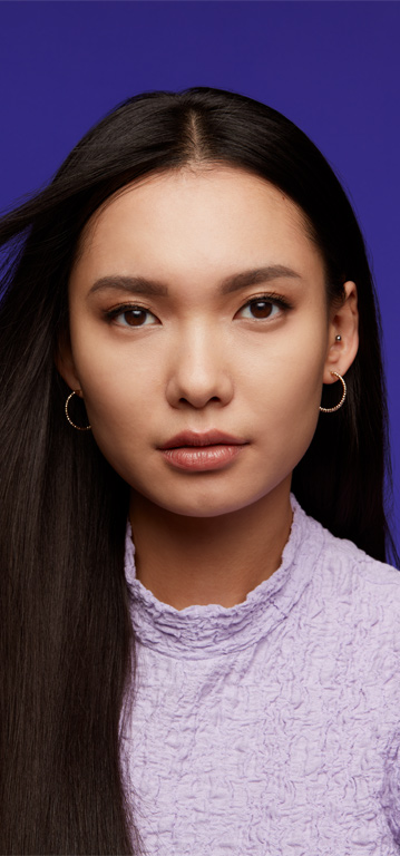 Woman looking at the camera wearing a neutral shade of Mary Kay Supreme Hydrating Lipstick